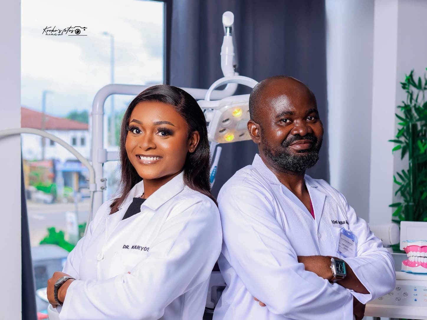 Smiling patient getting her teeth examined by a friendly dentist wearing purple gloves
